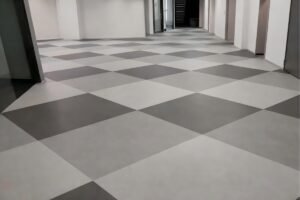 LVT dry back flooring installed in a checkerboard commercial project