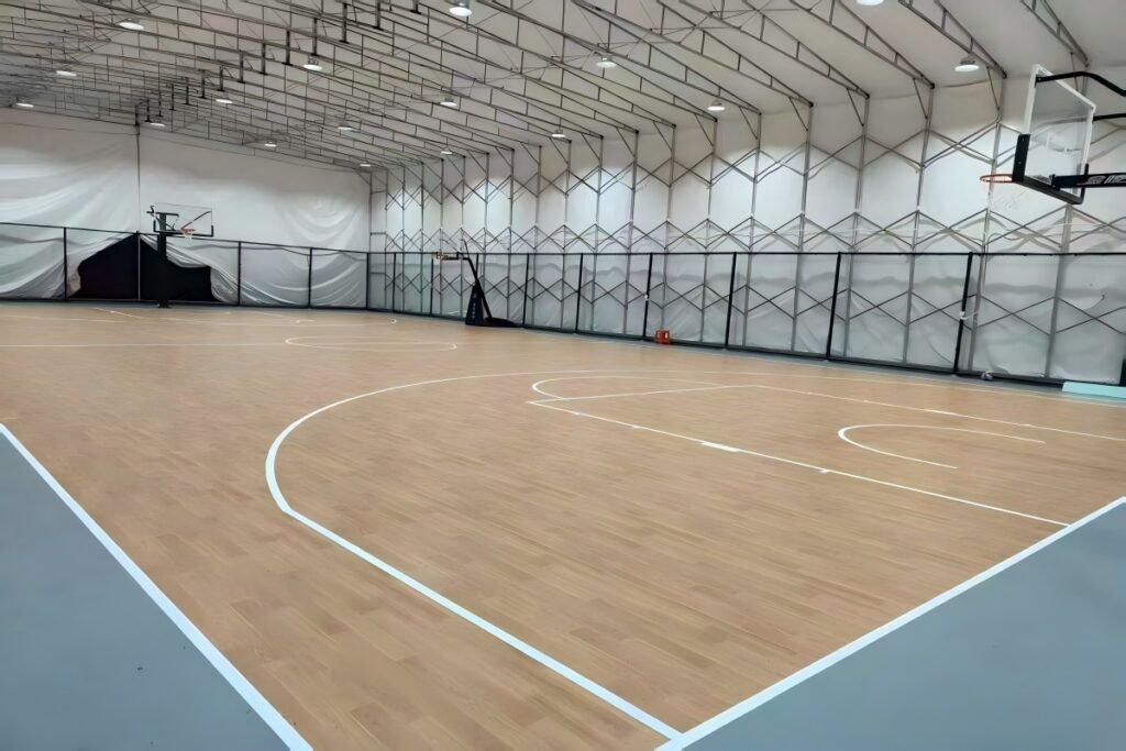 Wood grain PVC sports flooring installed in an indoor basketball court project